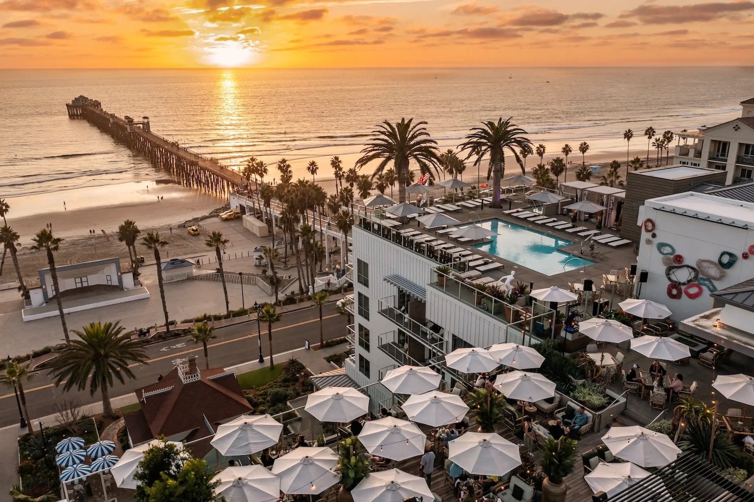 Aerial view of Mission Pacific Beach Resort's Rooftop bar in Oceanside at sunset with a view of the pier