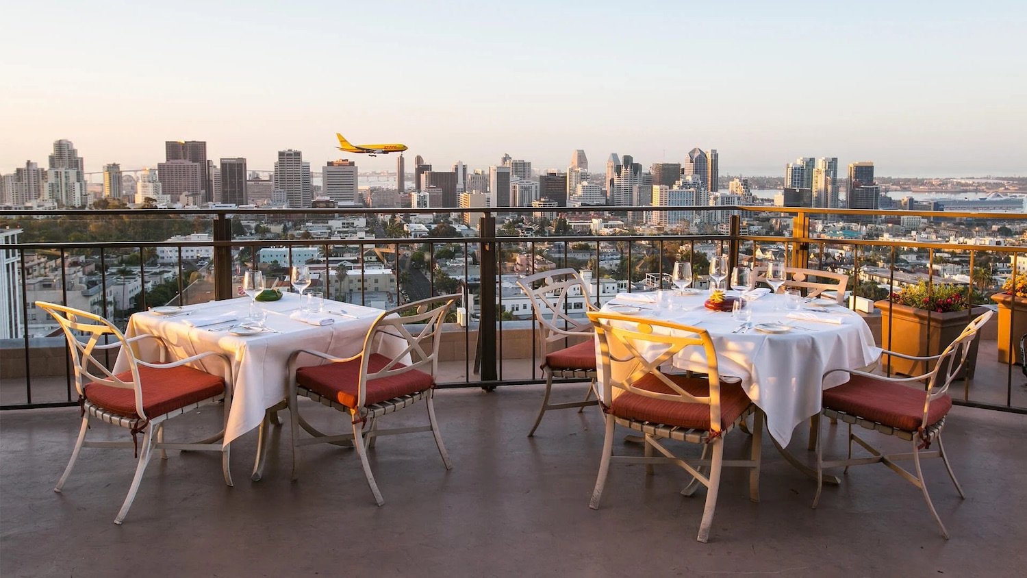 Outdoor patio at San Diego restaurant and bar Mister A's located in Bankers Hill with city skyline in background