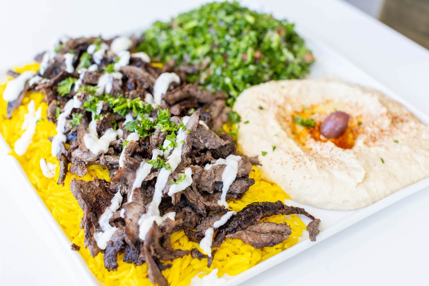 Food from San Diego food truck and Mediterranean restaurant Shawarma Guys featuring a beef Shawarma plate