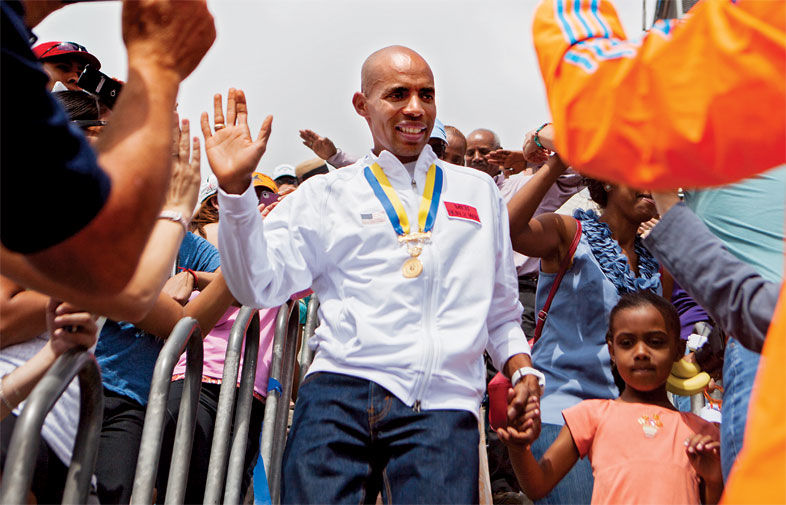 Meb Keflezighi, a Boston Marathon winner, throws out the ceremonial first  pitch before a baseball game between the Boston Red Sox and the Los Angeles  Angels, Friday, April 14, 2023, in Boston. (