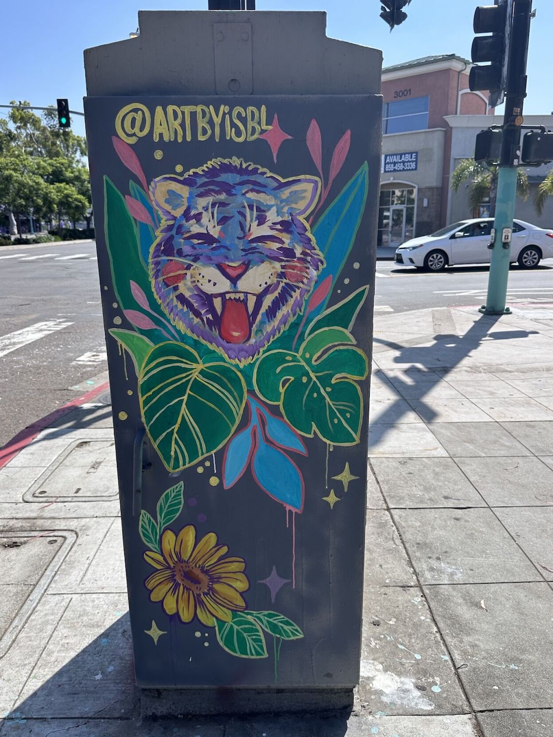 A San Diego utility box mural featuring illustrations of a wildcat and plants