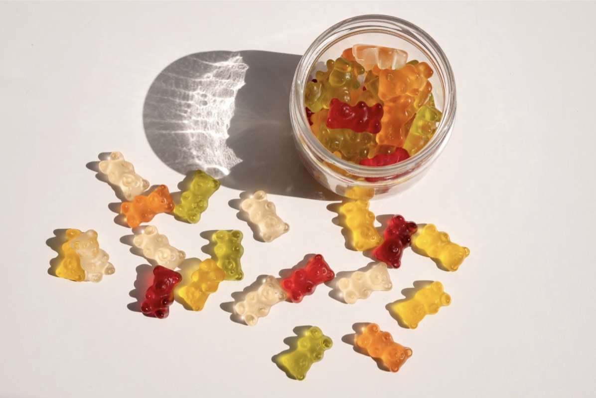 Gummy bears in a jar and sitting on a tabletop
