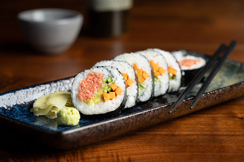 A Blue Nalu california sushi roll made of artificial fish on a plate