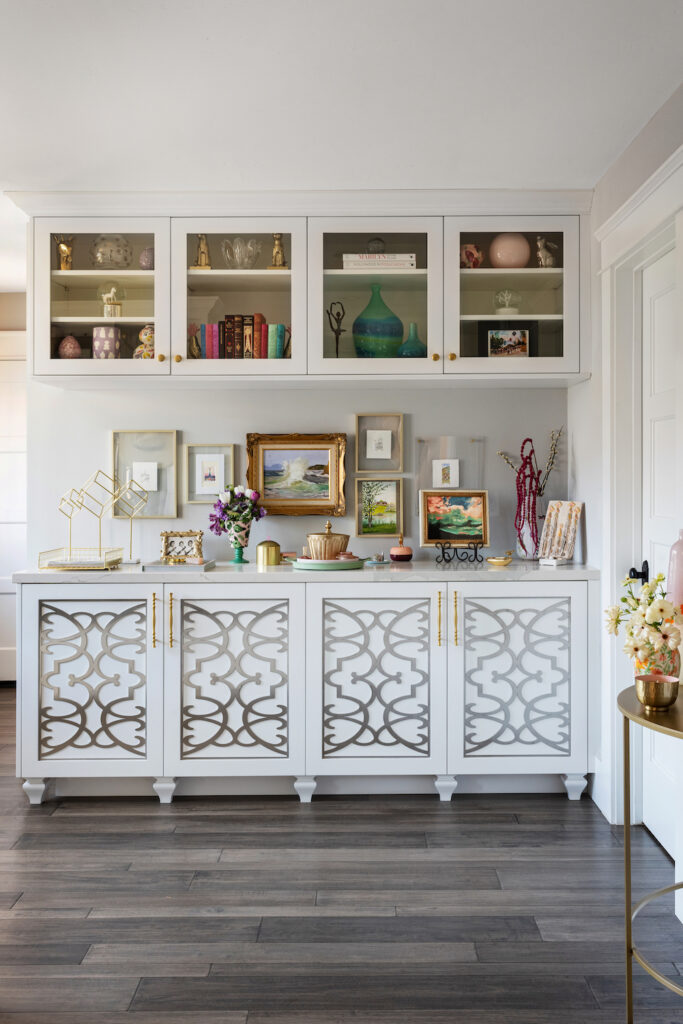 San Diego interior designer Lisa Franco's estate sale finds, art, and other decorations on a white cabinet in her home 