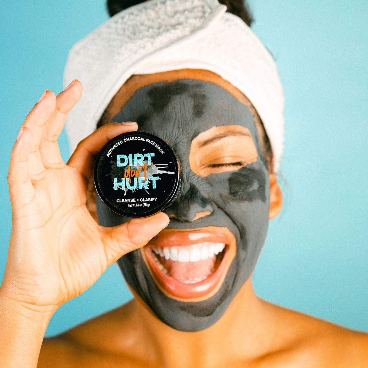 Dirt Don't Hurt Charcoal beauty company product featuring women with towel on head and charcoal facemask applied