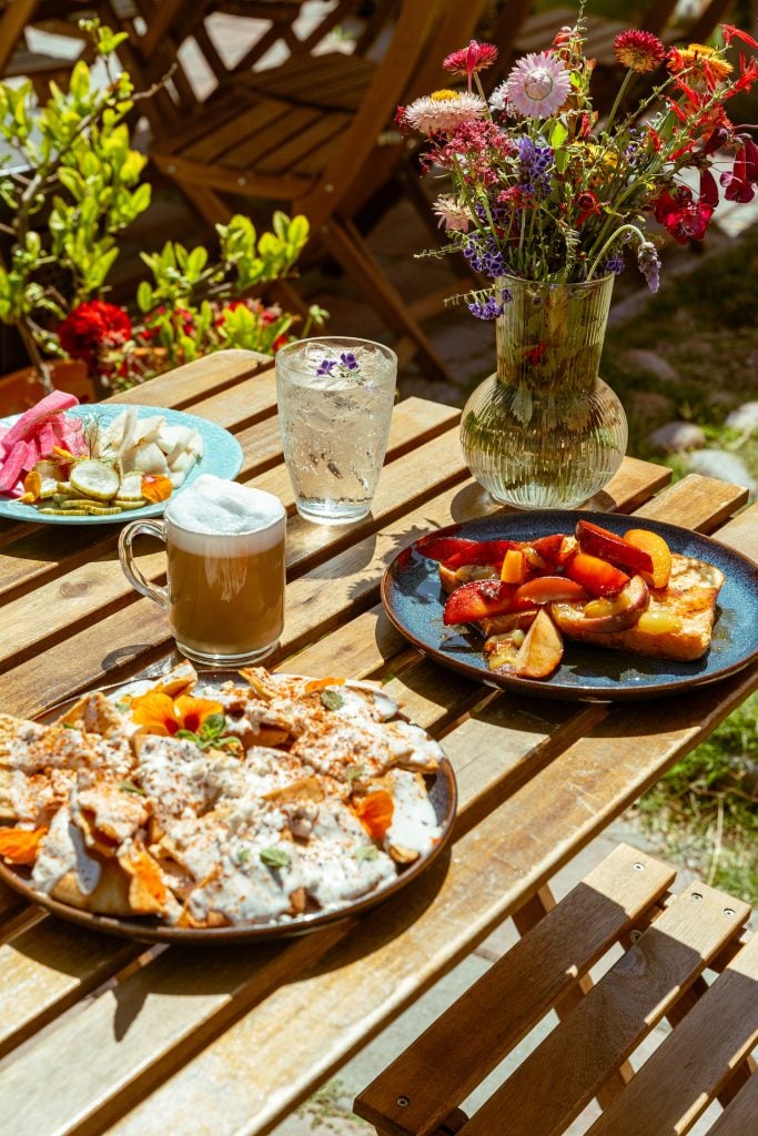 A table full of breakfast entrees and drinks available from MAKE Cafe in North Park, San Diego