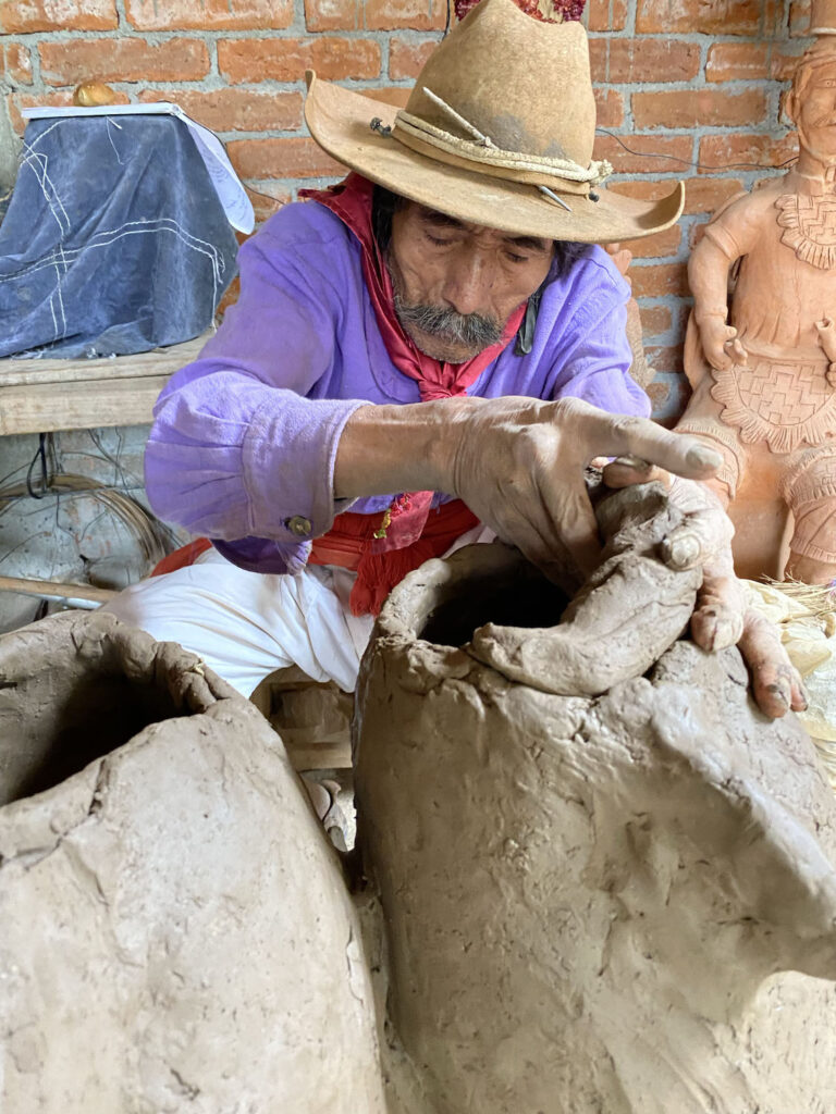 Blind sculptor Don José Garcia making a pot in his Oaxacan workshop