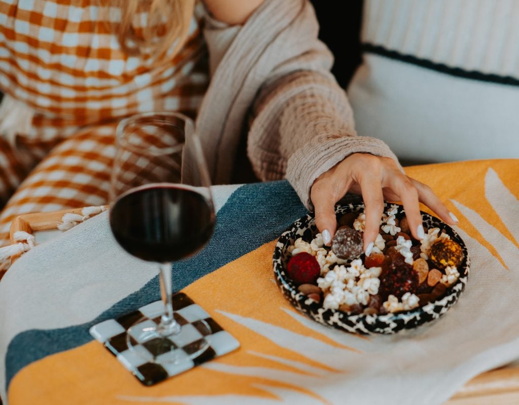 San Diego magazine holiday gift guide item movie night snack basket: yellow popcorn, garlic powder, gummy mix, carob-covered almonds from The Mighty Bin