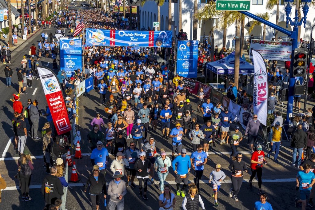Runners participating in the San Diego Turkey Trot event passing Pier View Way in Oceanside