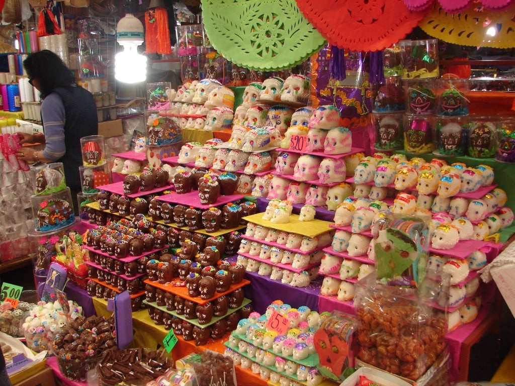 A Day of the Dead market vendor selling sugar skulls