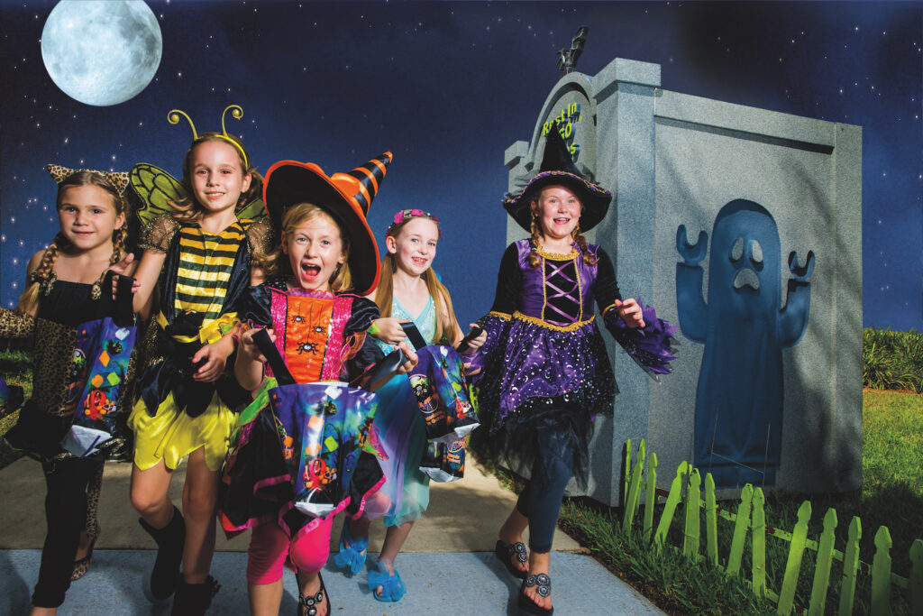 Girls dressed up for Halloween in a graveyard