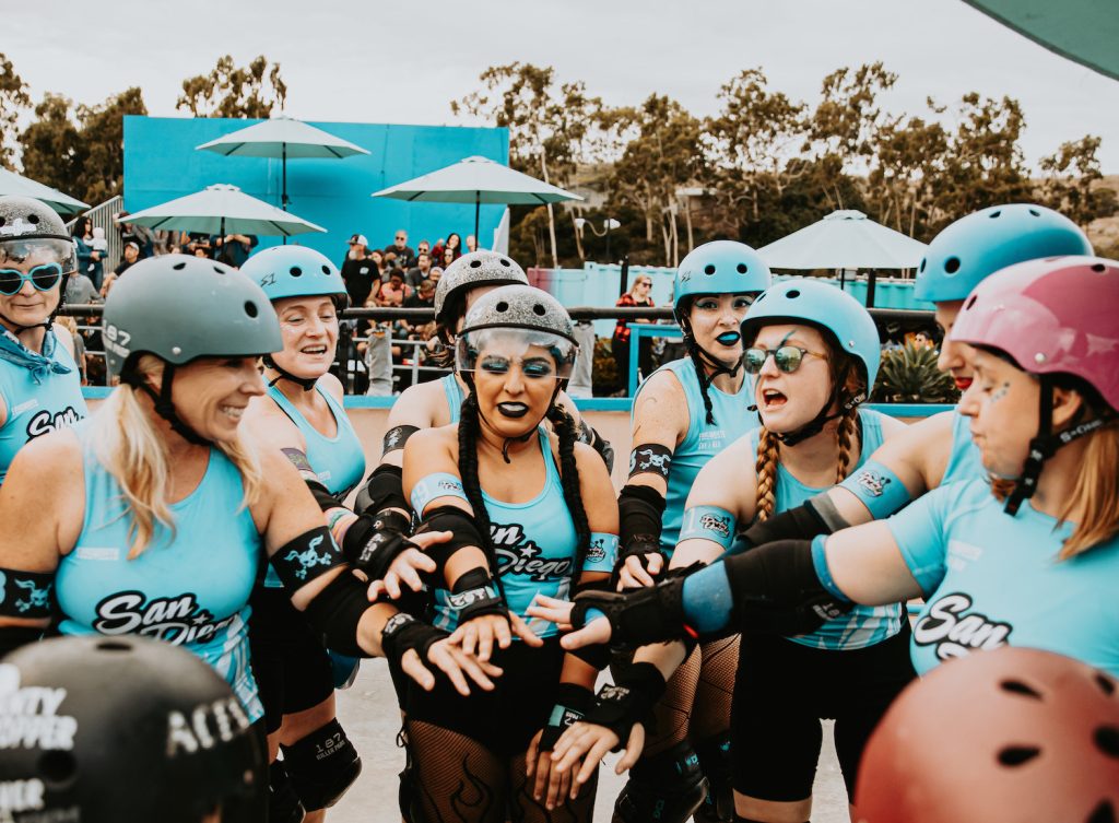 Roller derby players from the San Diego Wildfires huddle during a bout