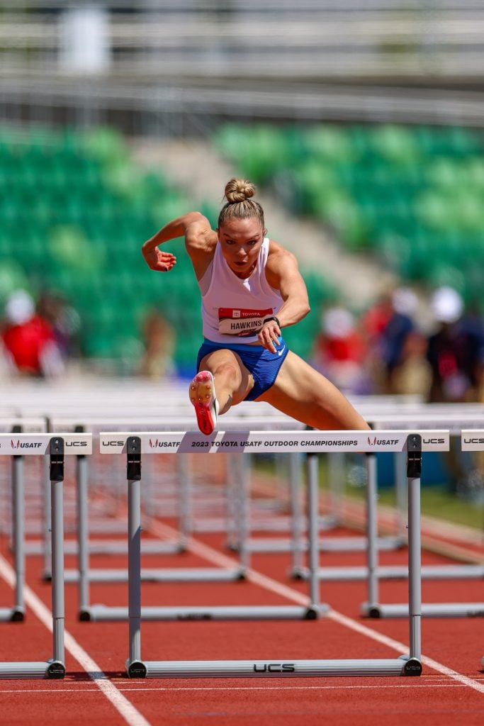 US gold medalist track & field athlete Chari Hawkins hurdling in an event