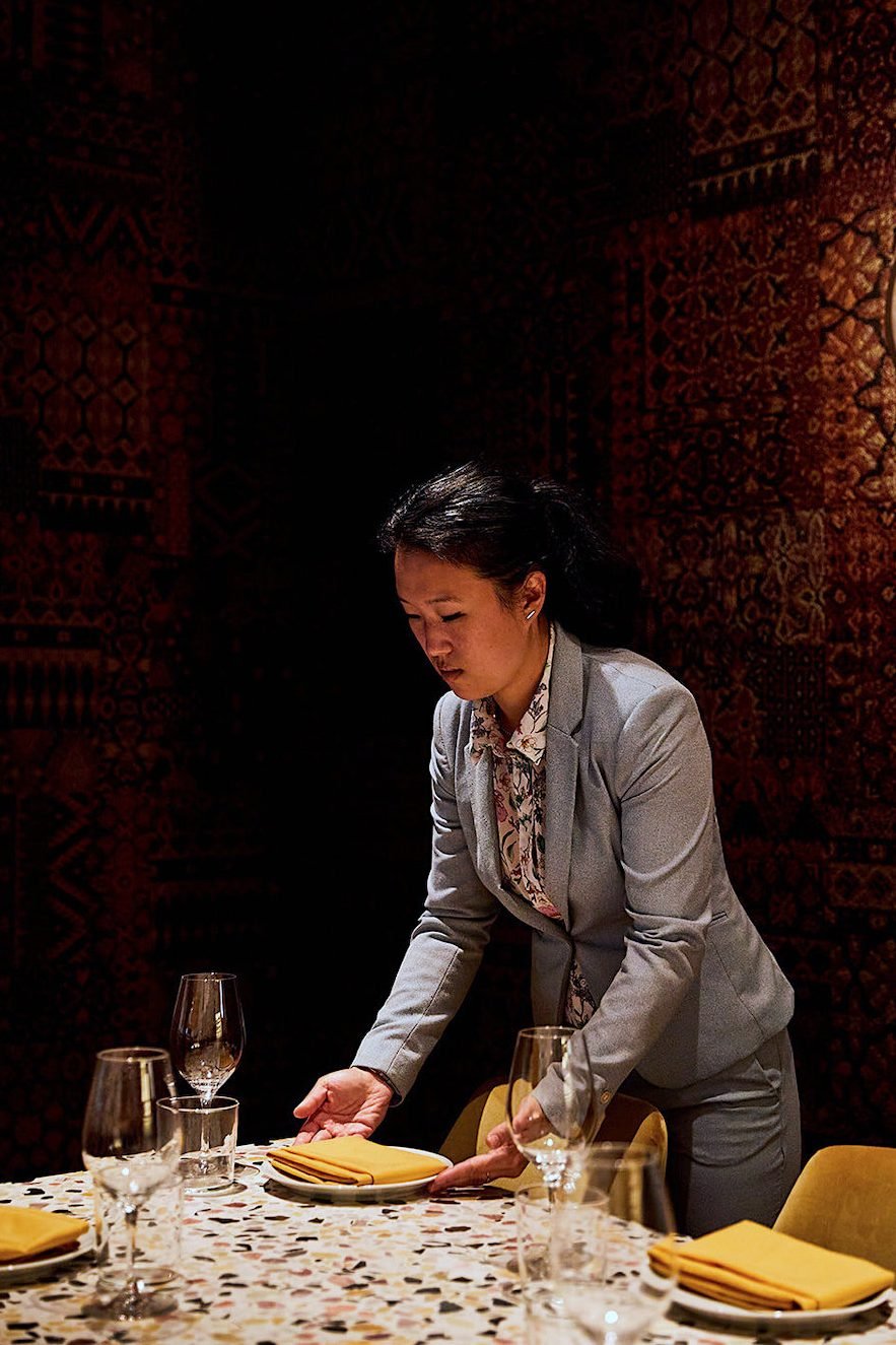 GM of restaurant Callie, Ann Sim, arranges a table before a dinner service