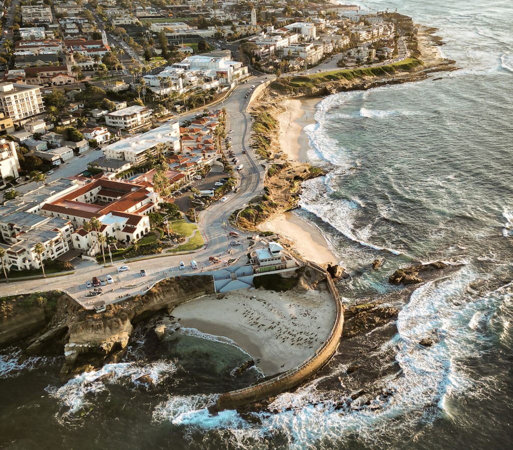 Aerial photo from Cole Novak of the La Jolla Cove, Tidepools, Children's Pool, and coastline down to Pacific Beach at sunset