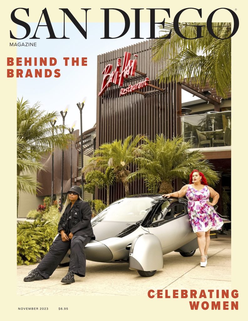 Food Network chef Claudia Sandoval stands alongside Tik Tok's head of global diversity Shavone Charles infront of an Aptera electric vehicle at San Diego restaurant Bali Hai