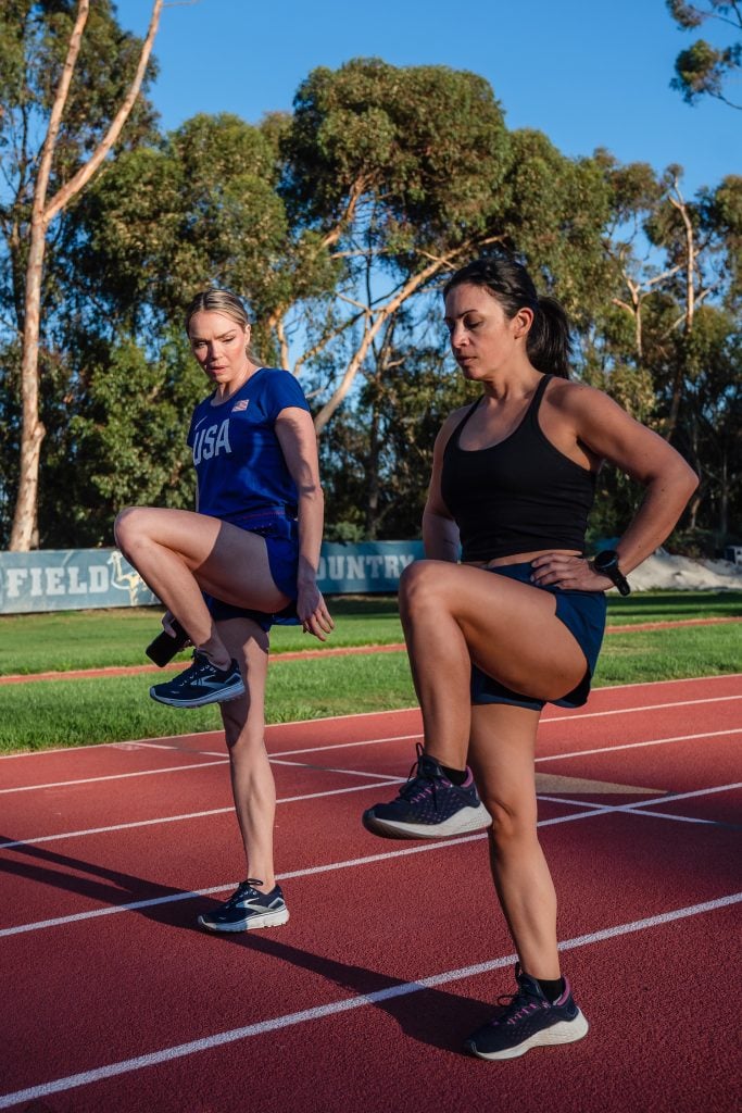 SDM's digital editor on a track stretching besides US track & field gold medalist Chari Hawkins