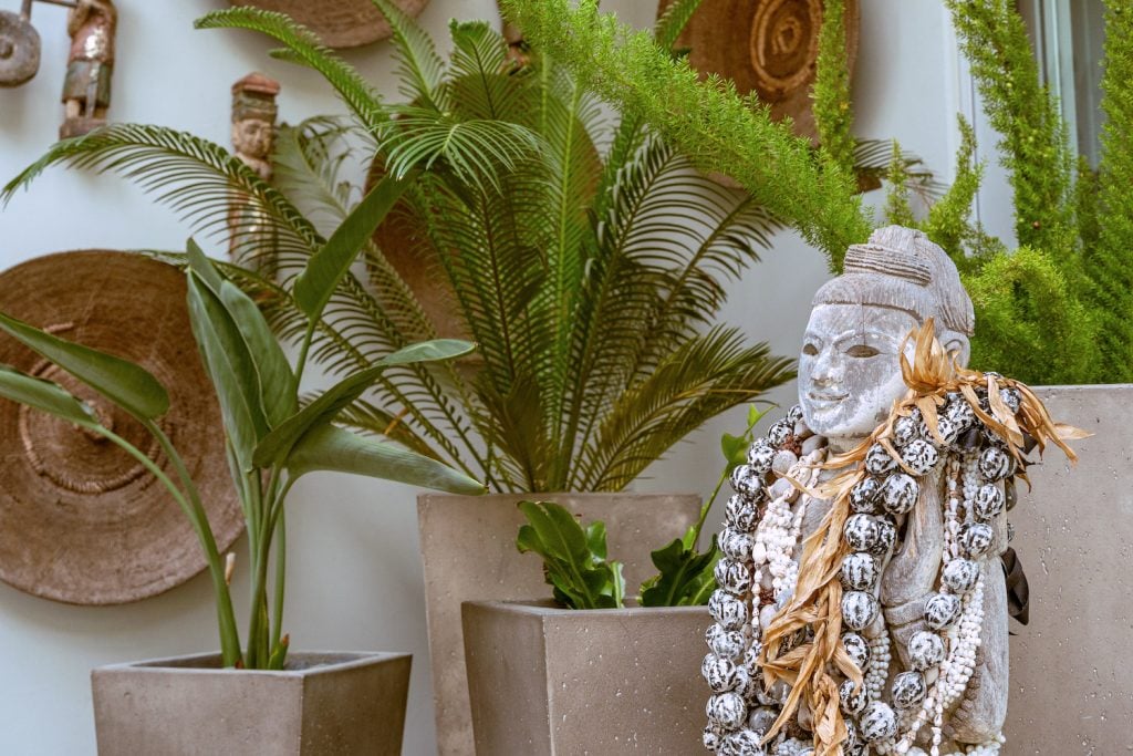 A Buddha statue, kukui shell necklaces, and other artifacts collected by Karen Krasne during her international travels