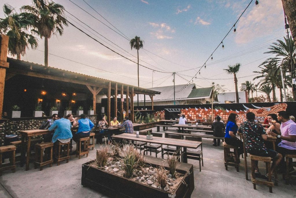 Baja California brewery Fauna Tasting Room's spacious outdoor patio featuring tables and string lights