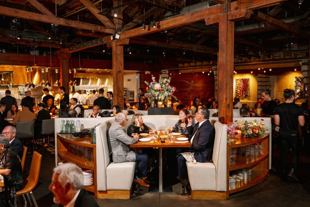 Interior of San Diego restaurant Juniper & Ivy featuring several large groups eating in their spacious dining room