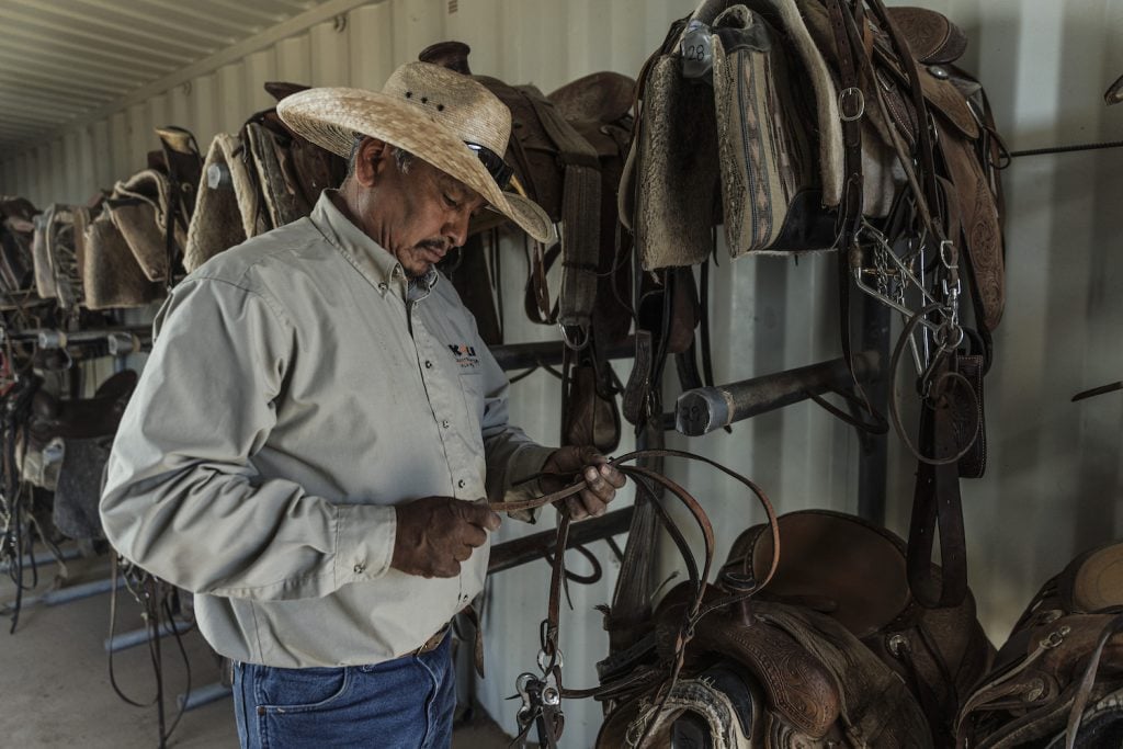 Chuck Pablo looking at saddles at the Wild Horse Pass