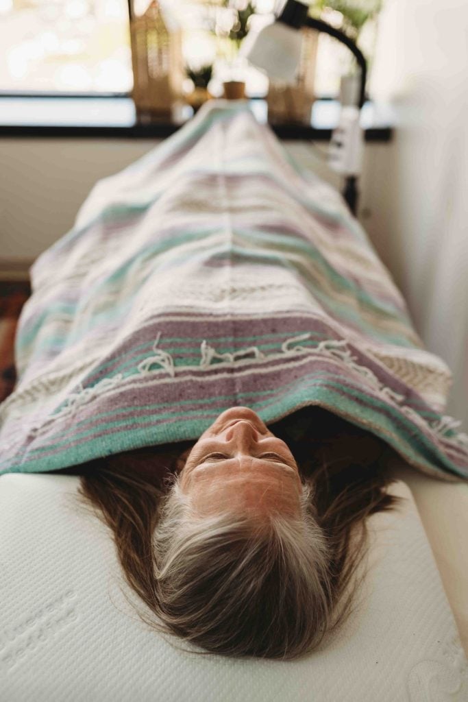 Patient at Monima Wellness Center lying on a bed 