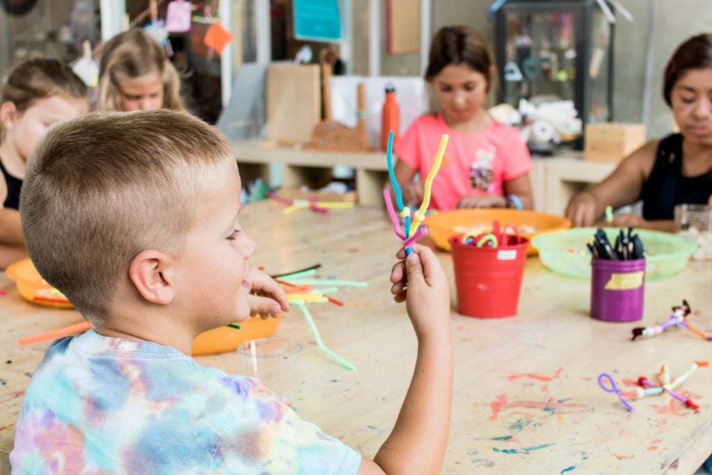 Kids making arts and crafts with pipe cleaners at the New Children's Museum in San Diego