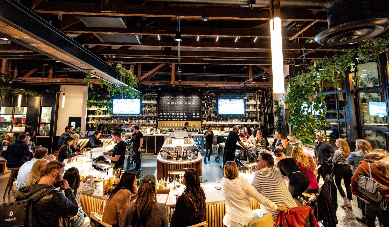 Large group of people eating at San Diego restaurant and bar Nolita Hall in Little Italy