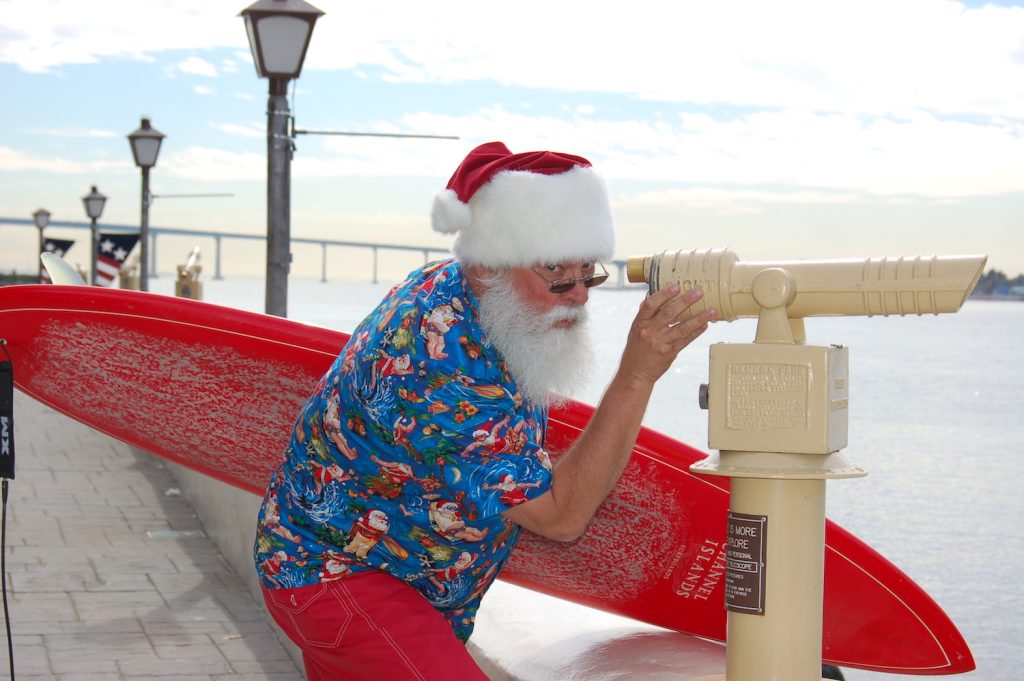 Santa with a surfboard at Seaport Village in San Diego 