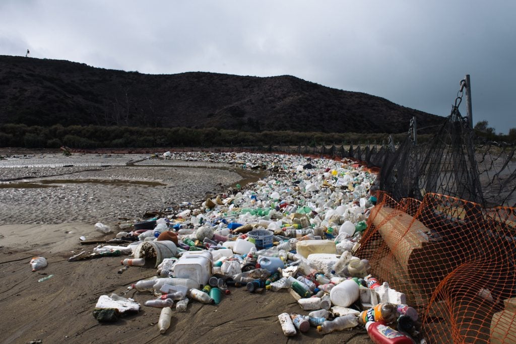 The San Diego Tijuana river full of trash caught by nets at the coastline 