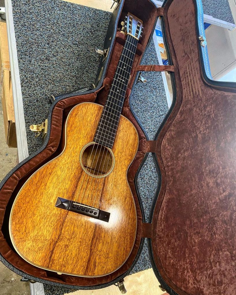 A koa wood acoustic guitar made by San Diego luthier Brandon Madrid