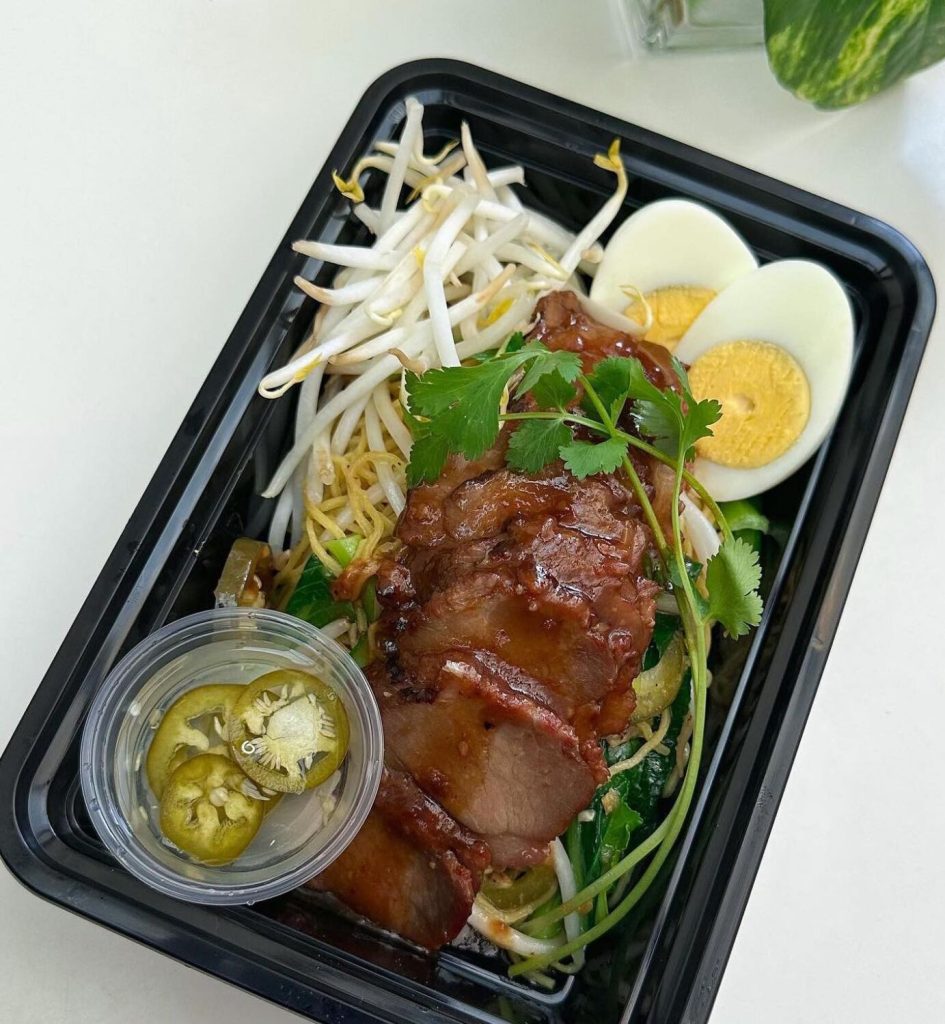 San Diego Magazine's Happy Half Hour Podcast thumbnail image featuring a to-go meal from Banh Thai featuring meat, sprouts, and egg
