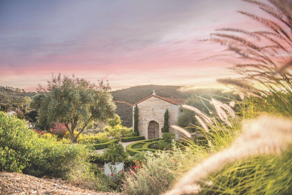 The Cal-a-Vie Health spa at sunset featuring a garden and rolling hills behind the retreat