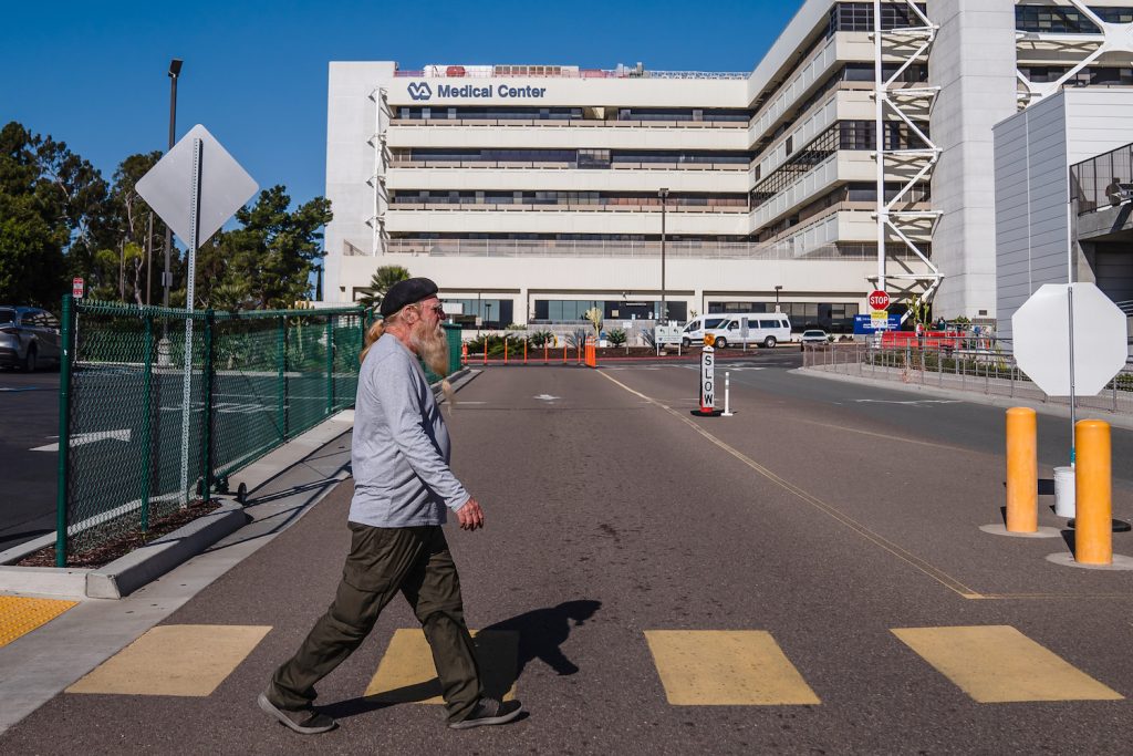 Tom Allen crossing a street towards the VA hospital to be fitted with hearing aids