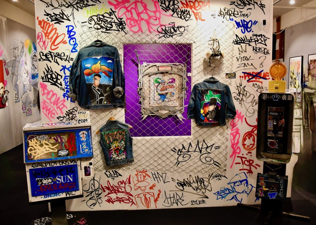 Grafitti art and embroidered denim jackets found Beyond the Elements San Diego Hip Hop history exhibit at the New Americans Museum