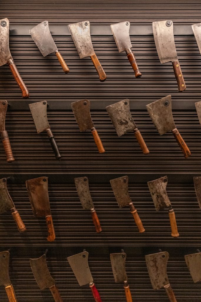 Steak 48 interior decor featuring a wall of hatchets along the wall
