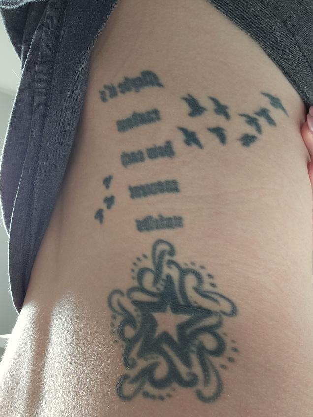 San Diego Magazine's user submitted regrettable tattoos featuring a lady's back with wilco song lyrics, a star, and a set of birds 