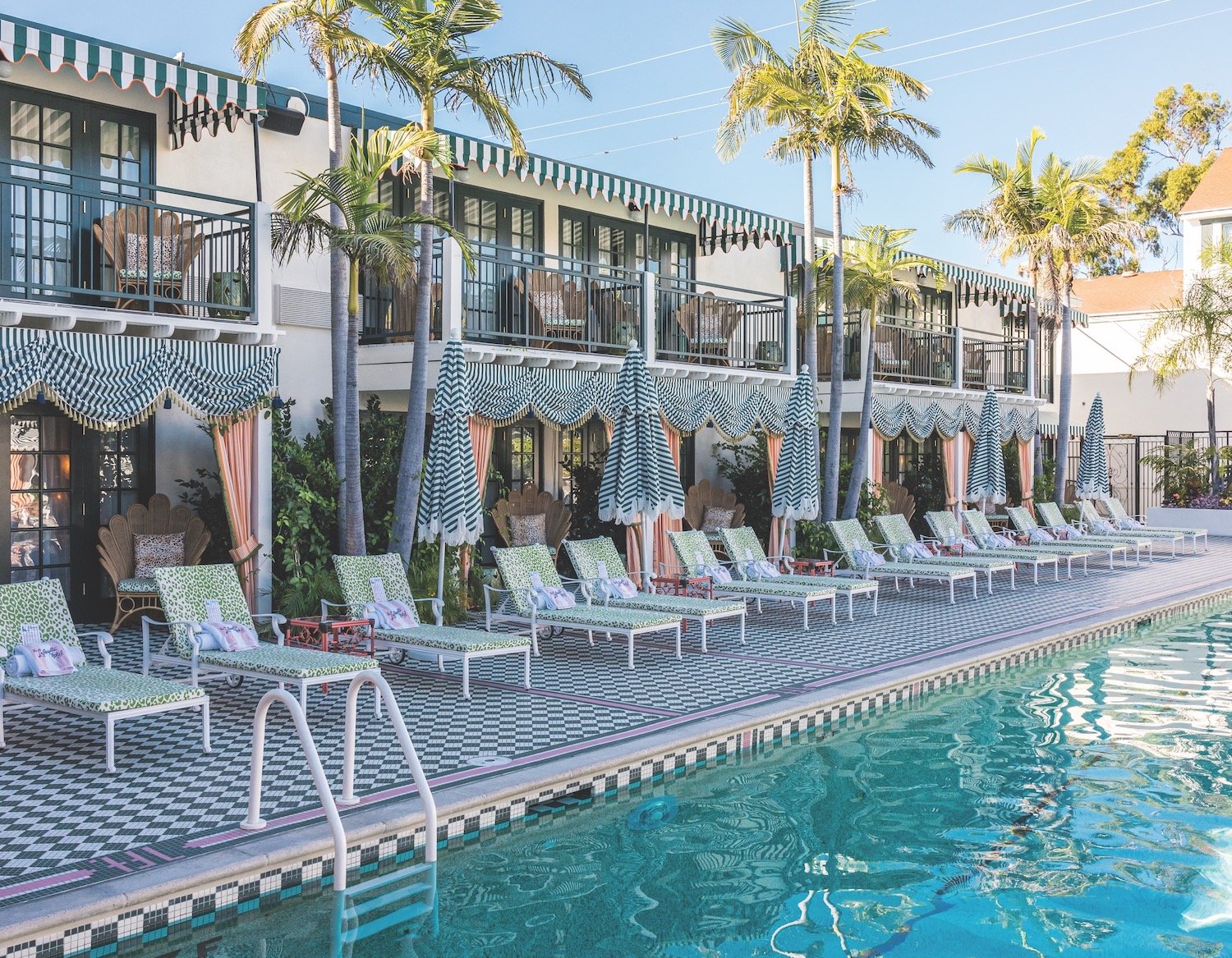 Consortium Holding's newly renovated Lafayette Hotel in North Park, San Diego featuring a pool, poolside cabanas, and lounge chairs