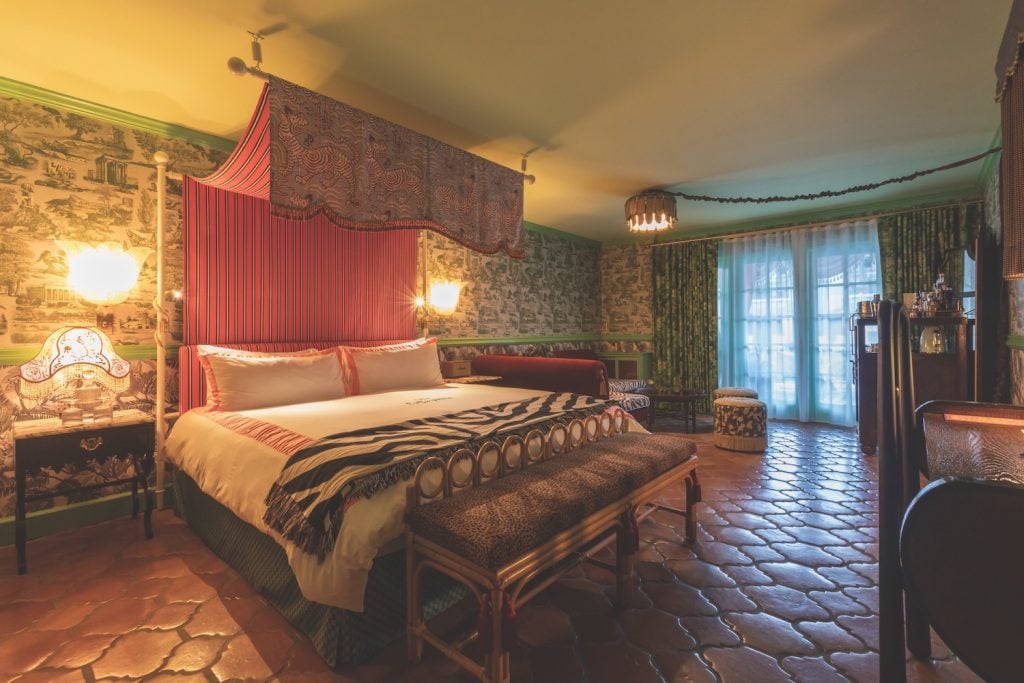Consortium Holding's newly renovated Lafayette Hotel in North Park, San Diego featuring a bedroom interior with custom Moroccan terracotta tile and a view of the courtyard 