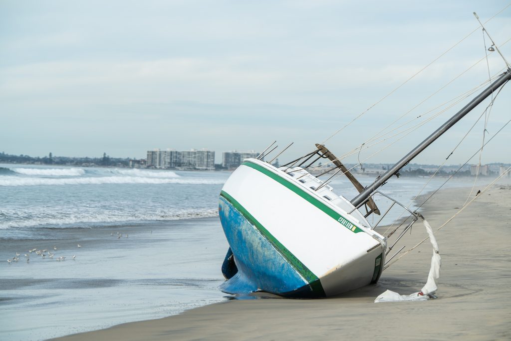 An abandoned ship at Silver Strand State Beach with Coronado and Downtown in the background 