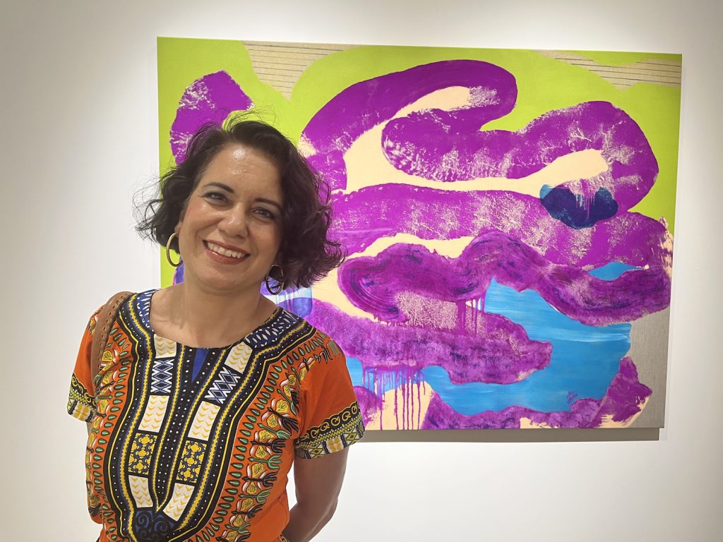San Diego Magazine contributor Alessandra Moctezuma standing in front of a painting in a museum as she overcomes grief