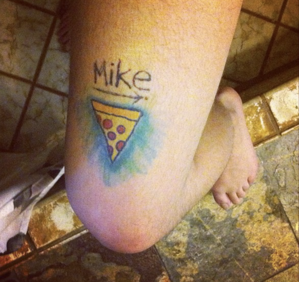 San Diego Magazine's user submitted regrettable tattoos featuring a leg tattoo with the text "Mike" and a pizza with an arrow