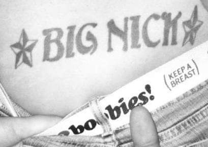 A tramp stamp tattoo with the text "Big Nick" and two stars on either side