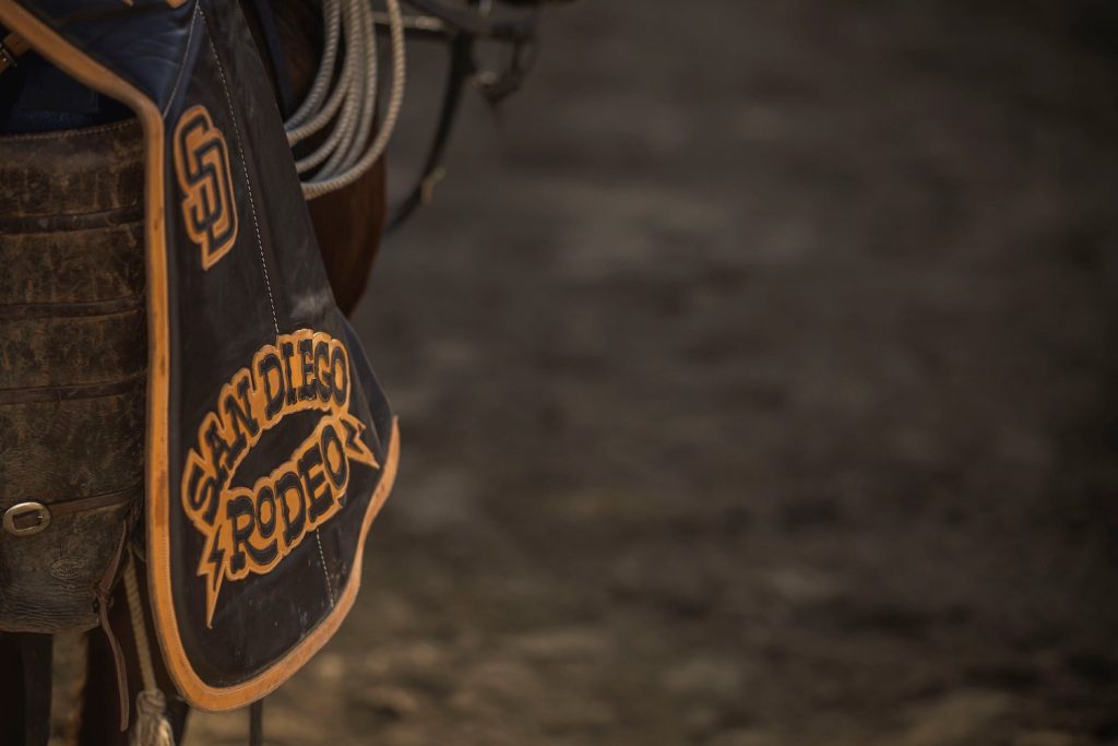 A saddle with the text "San Diego Rodeo" embroidered in the leather