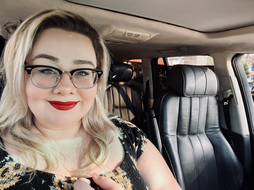 Katy Stegall sitting in her car as she reflects on her experience with plus sized fashion and poverty