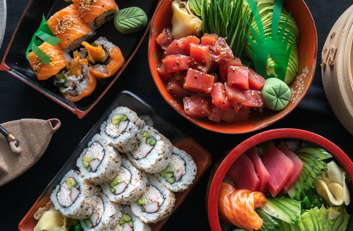 South Bay San Diego sushi and poke restaurant located in National City featuring a platter of sushi rolls, raw fish, and appetizers