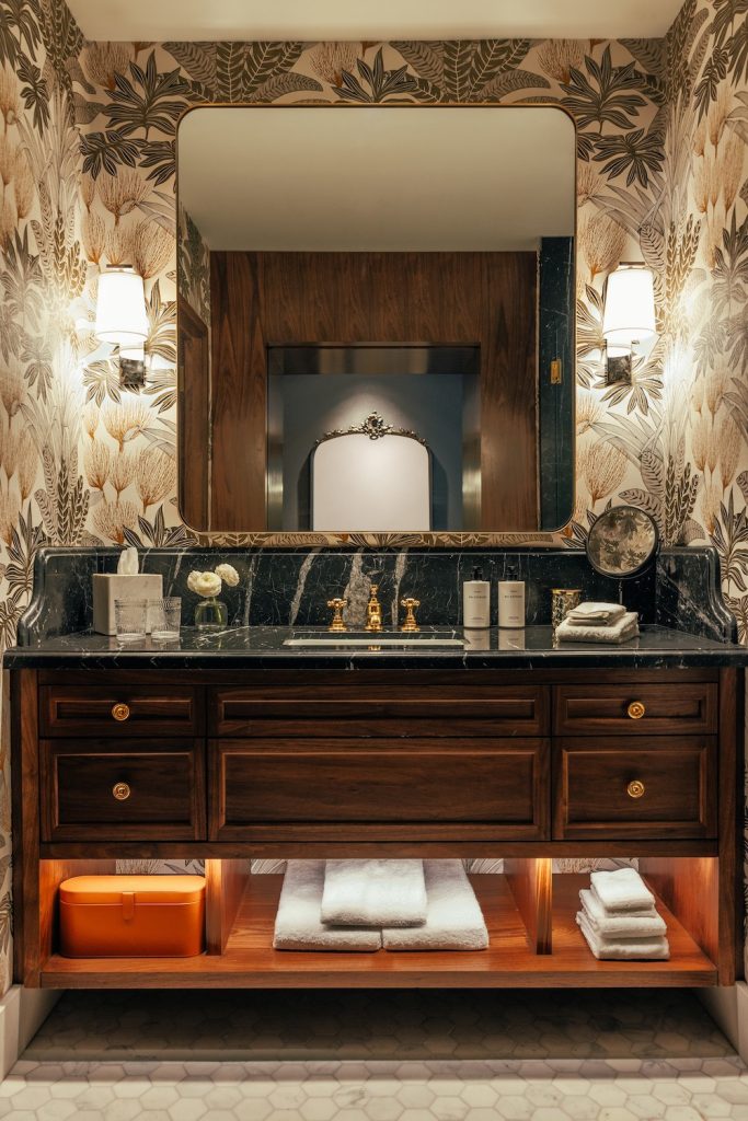 Interior of a bathroom at the Global Ambassador Phoenix luxury hotel, one of Nevada's most popular Mexican new hotels to visit in 2024, featuring Phillip Jeffries wallcoverings and artwork by Michael Carson