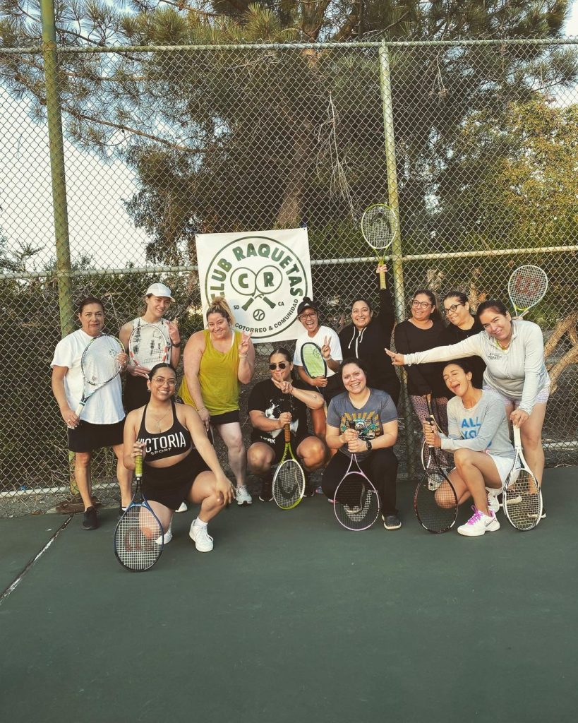 Latino tennis club Club Raquetas and their women's clinic practice posing for a picture on a tennis court in Chula Vista, San Diego
