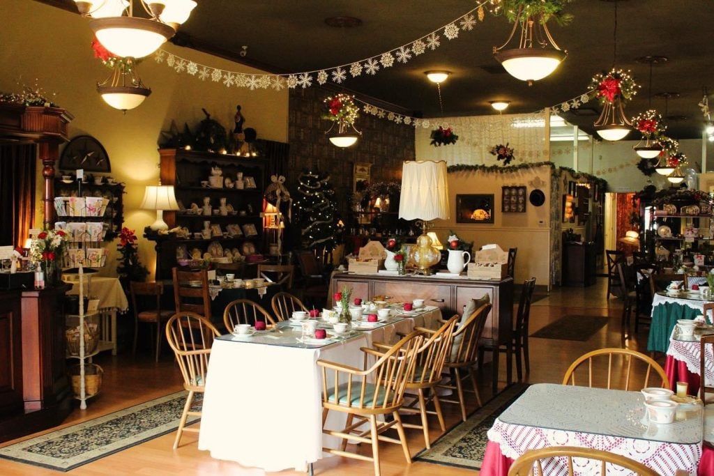 Interior of the Aubrey Rose Tea Room in La Mesa featuring a cozy, decorated interior featuring teacups and teapots on a table