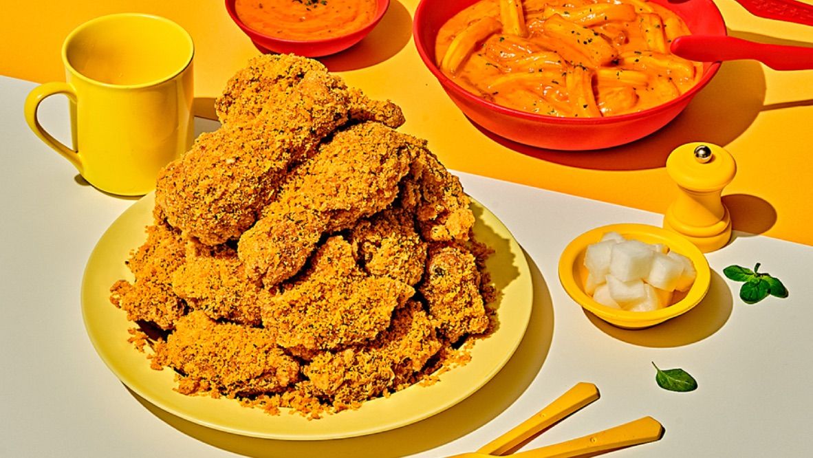 Famous Korean Fried Chicken restaurant BHC Chicken opens a new restaurant in San Diego featuring a plate full of chicken and sides